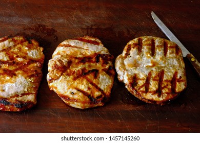 Grilled Boneless Pork Chops On Cutting Board