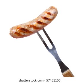Grilled bratwurst on a bbq fork isolated on white