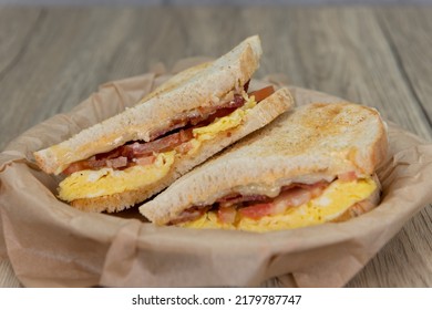 Grilled Breakfast Sandwich With Scrambled Eggs, Bacon, And Cheese On Sour Dough Toast Bread.