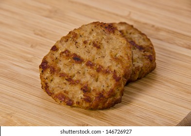 Grilled Breakfast Sausages Isolated On A  Wooden Plank.