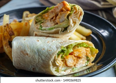 Grilled buffalo chicken sandwich wrap with romaine lettuce bleu cheese and fries