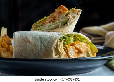Grilled buffalo chicken sandwich wrap with romaine lettuce bleu cheese and fries