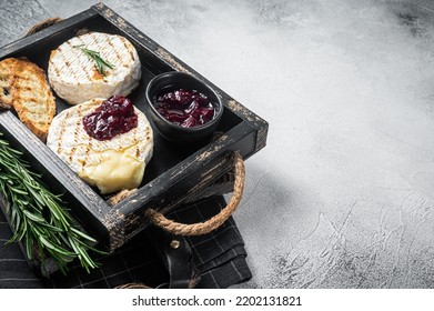 Grilled Camembert Brie Cheese With A Cranberry Sauce, Toast And Rosemary In A Wooden Tray. White Background. Top View. Copy Space.