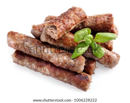Grilled cevapi with a basil leaf