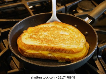 Grilled cheese sandwich being grilled in frying pan. - Powered by Shutterstock