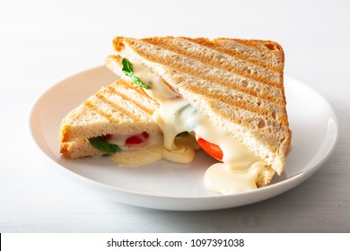 Grilled Cheese And Tomato Sandwich On White Background