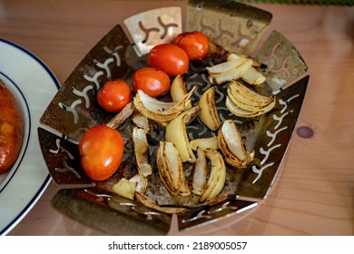 Grilled Cherry Tomatoes And Onions From A Charcoal Grill