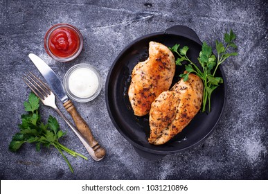 Grilled chicken breast or fillet on iron pan. Top view
