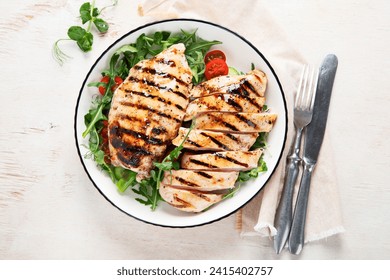 Grilled chicken breast, fillet, steak and fresh vegetable salad, on a white background. Healthy keto, ketogenic lunch menu with chicken meat and organic veggies. Top view. - Powered by Shutterstock