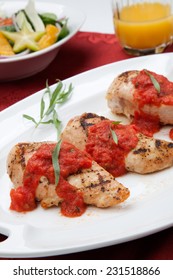 Grilled Chicken Breast With Fresh Tomato Tarragon Sauce, Spinach - Citrus Salad, And Orange Juice. 