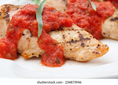 Grilled Chicken Breast With Fresh Tomato Tarragon Sauce, Spinach - Citrus Salad, And Orange Juice. 