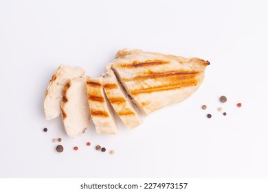 Grilled chicken breast isolated on white background. Grilled chicken slices with peper mix peas.