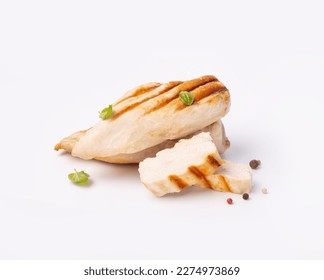 Grilled chicken breast isolated on white background. Grilled chicken slices with pepper mix peas and fresh basil leaves.