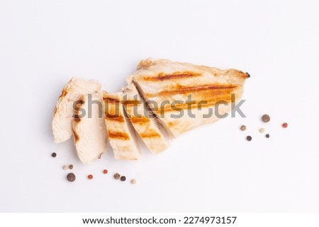Grilled chicken breast isolated on white background. Grilled chicken slices with peper mix peas.
