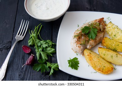 Grilled Chicken Breast With Roasted Potatoes On White Plate