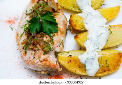 Grilled Chicken Breast With Roasted Potatoes On White Plate