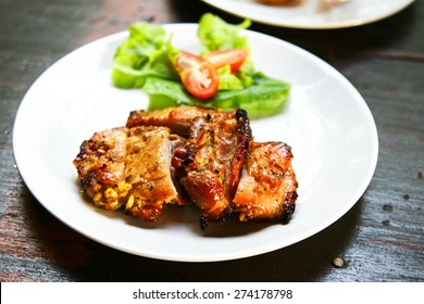 Grilled Chicken Breast With  Salad In White Plate  Isolated On Black Table, Selective Focus