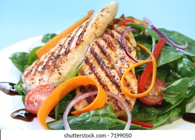 Grilled Chicken Breast With A Spinach Salad, With A Balsamic Reduction.