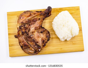 Grilled chicken drumstick  and Sticky rice on wooden background 