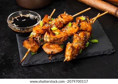 Grilled chicken fillet on skewers in teriyaki sauce. Asian style.