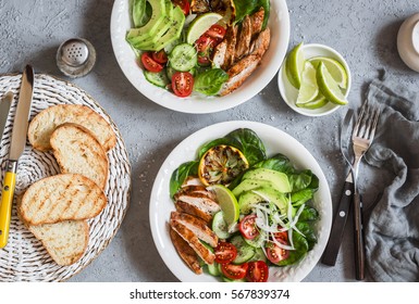 Grilled chicken and fresh vegetable salad. Healthy diet food concept. On a light background, top view  