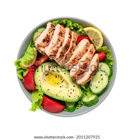 Grilled chicken with fresh vegetable salad with seeds in a bowl isolated on white background. View from above. Healthy food and keto diet concept