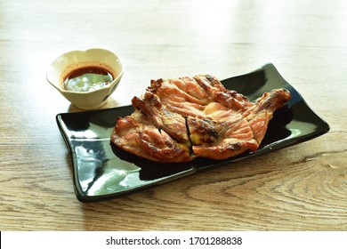 Grilled Chicken Hip And Leg On Plate Dipping With Spicy Tamarind Sauce