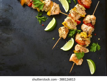 Grilled chicken kebab with vegetables on a black background.Copy space.