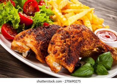 Grilled Chicken Leg With Chips And Vegetables