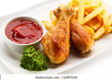 Grilled Chicken Legs With Chips And Vegetables