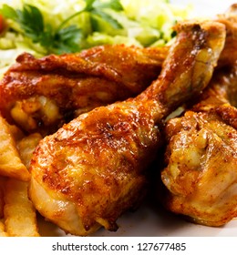 Grilled Chicken Legs With Chips And Vegetables