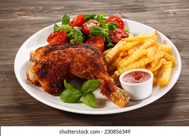 Grilled Chicken Legs With Chips And Vegetables