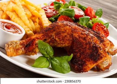 Grilled Chicken Legs With Chips And Vegetables