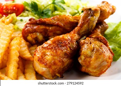 Grilled Chicken Legs With Chips And Vegetables 