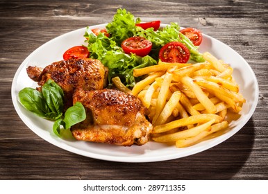 Grilled Chicken Legs With Chips And Vegetables 