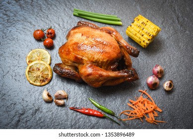 Grilled Chicken on plate dark background with grilled tomatoes lemon chilli spicy shallot garlic corn and carrot on dining table food - Shutterstock ID 1353896489