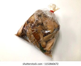 Grilled Chicken In Plastic Bag On White Background