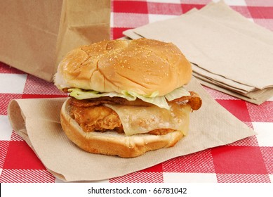 A Grilled Chicken Sandwich With Swiss Cheese And Bacon