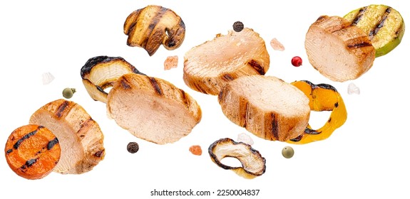 Grilled chicken slices and chopped vegetables isolated on white background - Powered by Shutterstock