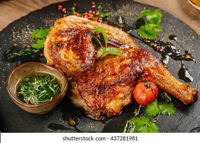 Grilled Chicken Tabaka With Sauce On Stone Plate.