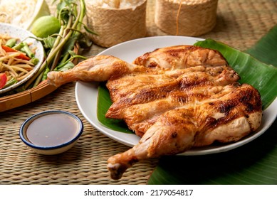 Grilled chicken Thai Food Style on wooden table background. Menu Som Tum Thai - Papaya Salad Concept.  Top View.