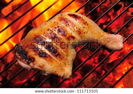 Grilled chicken thigh on the flaming grill Stock fotó © 