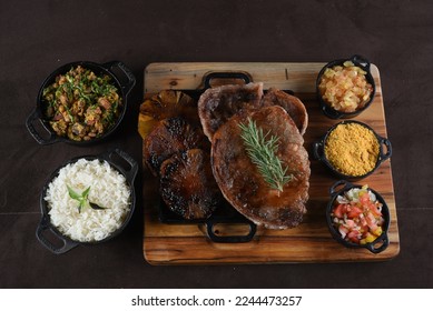 Grilled Chuck Eye Roll Steak roasted on a chopping board. bbq barbecue with rice beans salad. top view - Shutterstock ID 2244473257