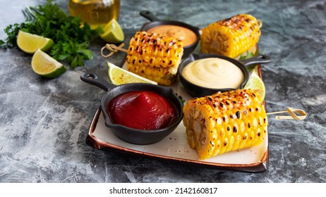 Grilled Cob Corn With Spices Lime White Yellow Red Sauce Close Up