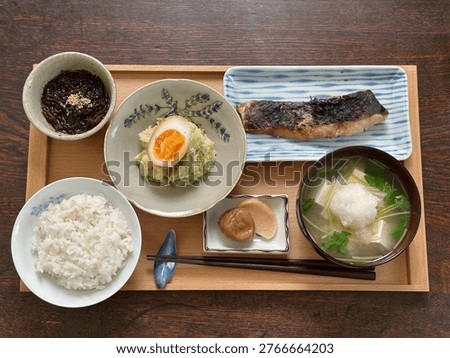 Grilled cod marinated in sweet sake and miso, potato salad with butterbur sprouts, mozuku seaweed salad, homemade pickled radish and pickled plums, rice with barley, and miso soup with enoki mushrooms and tofu.