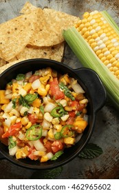 Grilled Corn Mango Tomato Salsa With Chips Served In A Black Salsa Bowl, Selective Focus