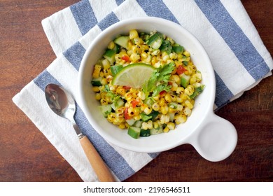 Grilled Corn Salad With Cucumber, Coriander, Chili And Lime. White Plate. Wooden Table.