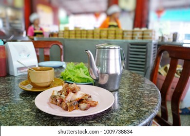 Grilled crispy pork, it’s popular breakfast food served with vegetables and sweet sauce, in Trang, Thailand. Selective focus. - Powered by Shutterstock