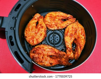 Grilled Delicious Spicy  Salmon Pieces On Air Fryer Basket. Air Fryer Helps To Cook Foods Without Oils- Healthy Cooking Concept