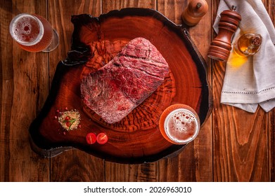 Grilled Denver Steak With Two Glasses Of Beer On Wooden Cutting Board. Marble Meat Beef - Top View.